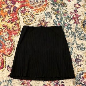 Super cute black skirt with cute ruffles on the bottom, and fringe at the top!